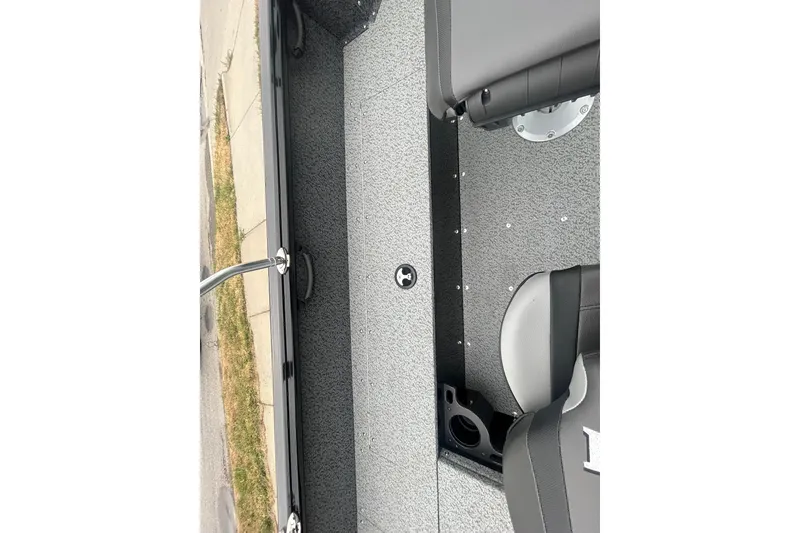 Slide: The Image of 2026 Lund 1700 Explorer Sport boat interior with gray seating and textured flooring. - 25