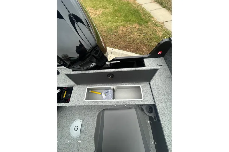 Slide: The Image of 2026 Lund 1700 Explorer Sport boat interior with storage compartments and motor view. - 26