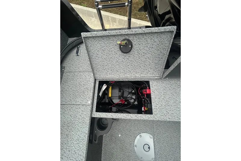 Slide: The Image of 2026 Lund 1700 Explorer Sport boat interior with open storage compartment and wiring. - 28