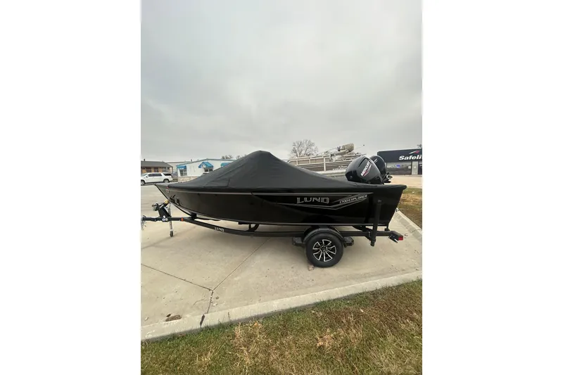 Slide: The Image of 2026 Lund 1700 Explorer Sport boat with cover on trailer, parked outdoors. - 3