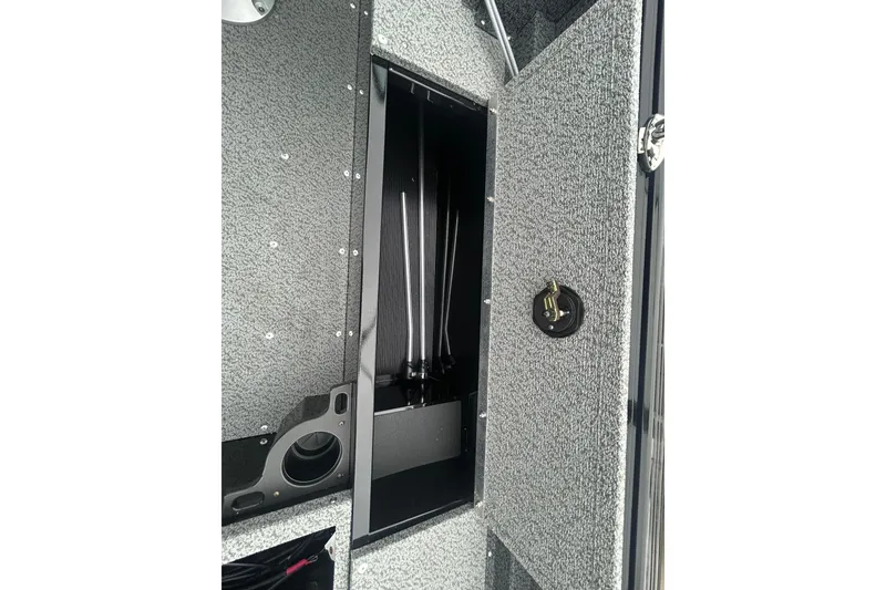 Slide: The Image of 2026 Lund 1700 Explorer Sport interior storage compartment with open hatch. - 30