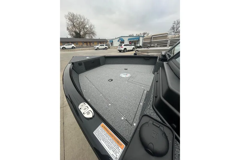 Slide: The Image of 2026 Lund 1700 Explorer Sport boat interior, featuring spacious deck and storage compartments. - 32