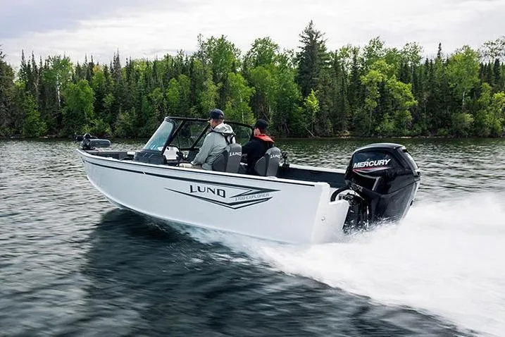 Slide: The Image of Manufacturer Provided Image: 2026 Lund 1700 Explorer Sport boat cruising on a lake with forested shoreline. - 37