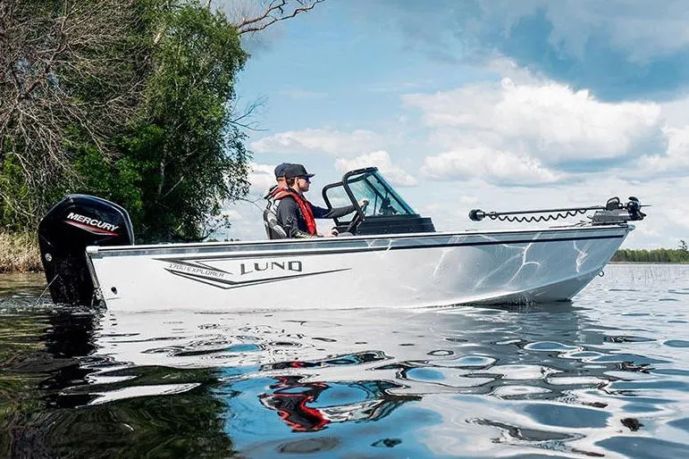 Slide: The Image of Manufacturer Provided Image: 2026 Lund 1700 Explorer Sport boat on a calm lake with blue sky. - 40
