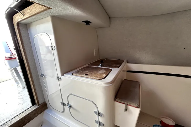 Slide: The Image of 1989 Cigarette Cafe Racer 35 interior with compact kitchenette and storage. - 16