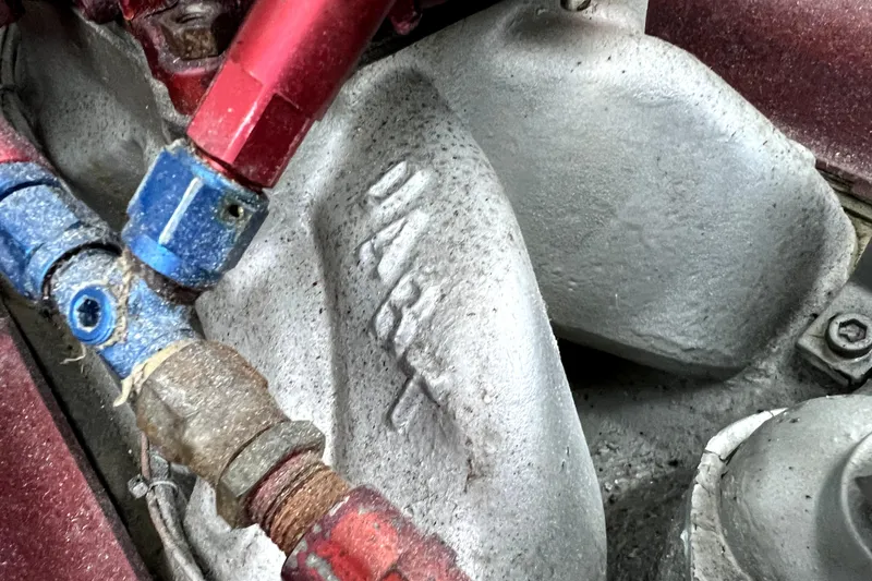 Slide: The Image of Close-up of 1989 Cigarette Cafe Racer 35 engine components with red and blue fittings. - 22