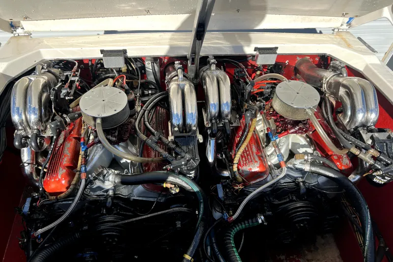 Slide: The Image of Twin engines of a 1989 Cigarette Cafe Racer 35 boat, showcasing chrome and red components. - 24