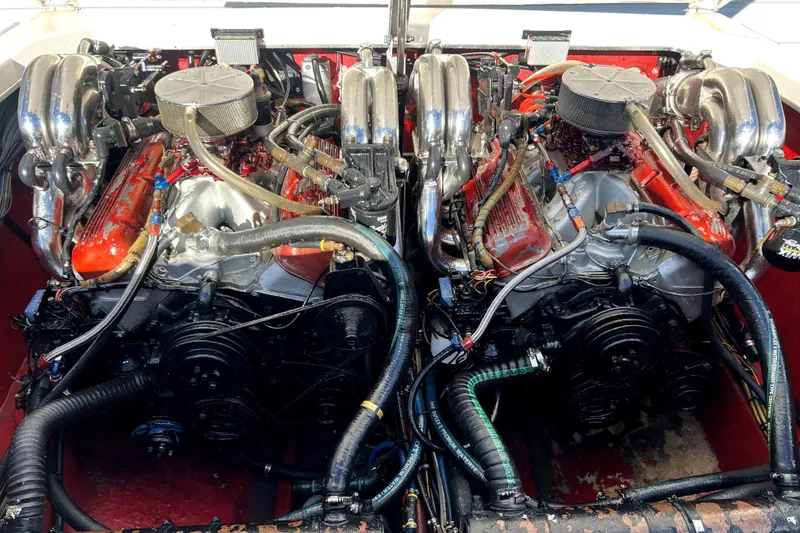 Slide: The Image of Twin engines of a 1989 Cigarette Cafe Racer 35 boat, showcasing intricate mechanical details. - 25