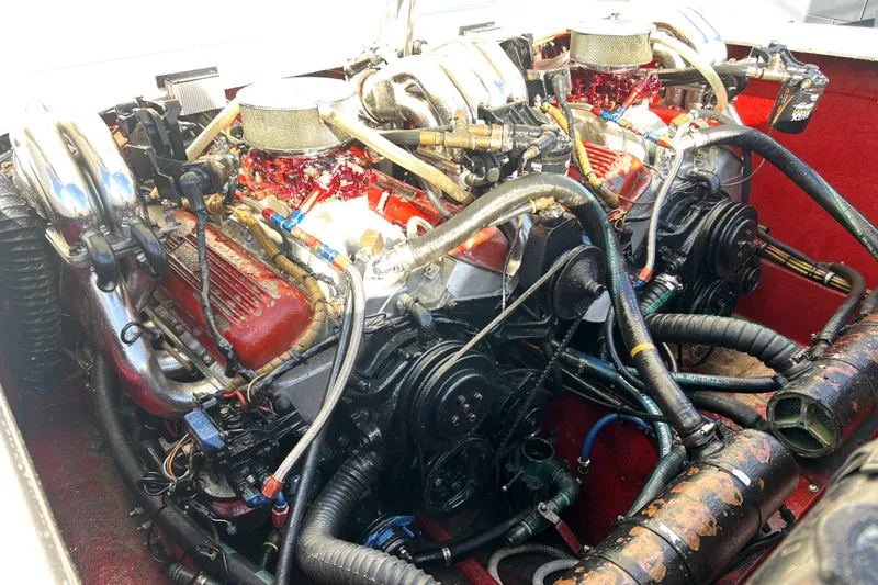 Slide: The Image of Engine of 1989 Cigarette Cafe Racer 35, showcasing dual carburetors and intricate piping. - 26