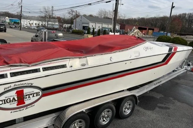 Slide: The Image of 1989 Cigarette Cafe Racer 35 boat on trailer, parked on urban street. - 4