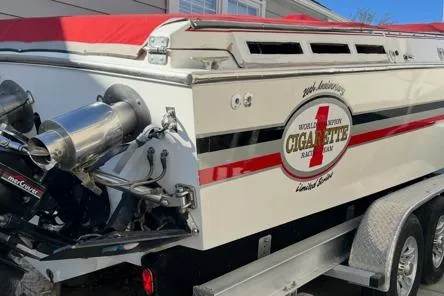 Slide: The Image of 1989 Cigarette Cafe Racer 35 boat with red cover and dual exhausts on trailer. - 5