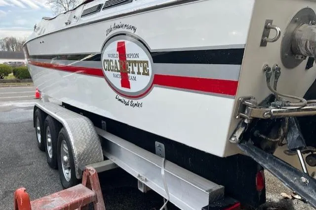 Slide: The Image of 1989 Cigarette Cafe Racer 35 boat on trailer, featuring racing team logo. - 6
