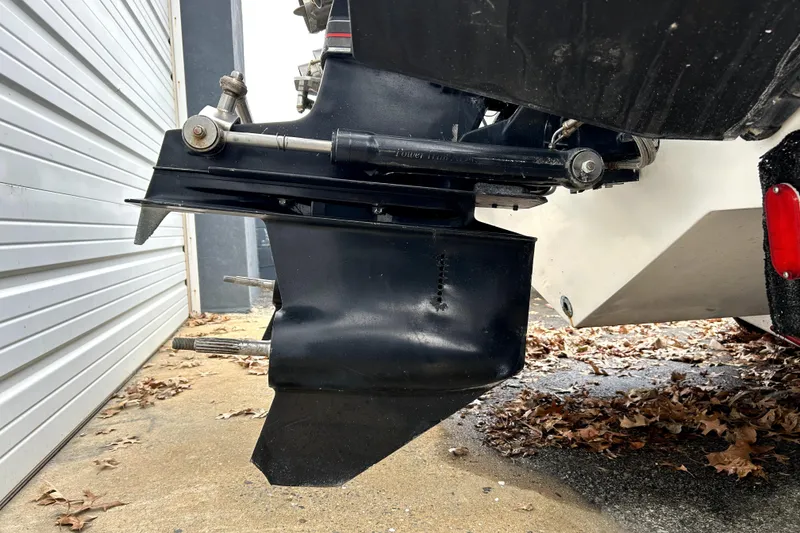 Slide: The Image of 1989 Cigarette Cafe Racer 35 boat engine detail with leaves on the ground. - 9