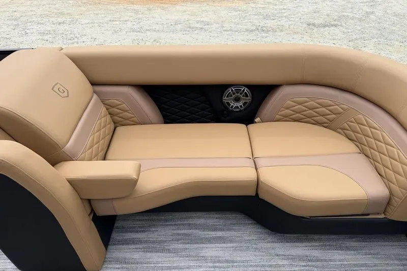 Slide: The Image of Luxurious tan seating on 2026 Godfrey Monaco 235 SFLC iMPACT boat, featuring quilted design and speaker. - 7