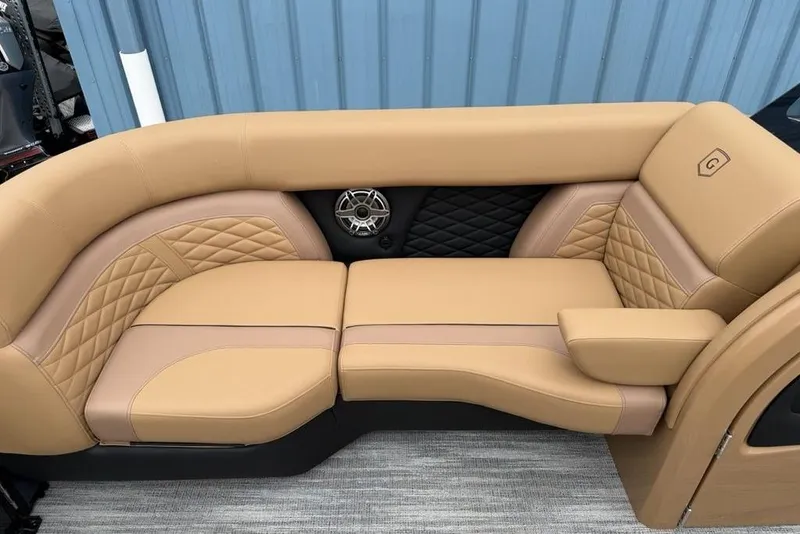 Slide: The Image of Luxurious tan seating on 2026 Godfrey Monaco 235 SFLC iMPACT boat, featuring quilted design and speaker. - 8
