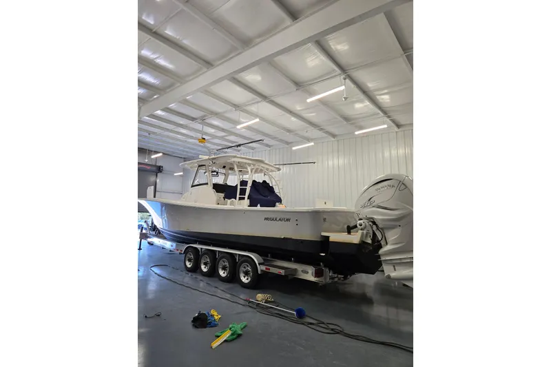 Slide: The Image of 2020 Regulator 41 boat in a warehouse on a trailer. - 36