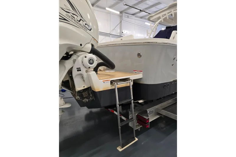 Slide: The Image of 2020 Regulator 41 boat with ladder and outboard motor in a garage setting. - 43