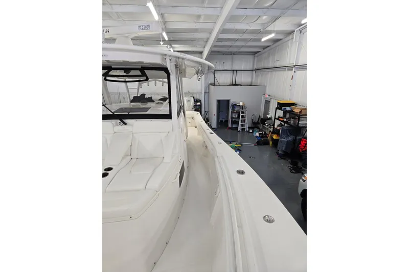 Slide: The Image of 2020 Regulator 41 boat in a workshop, showcasing sleek design and spacious interior. - 48