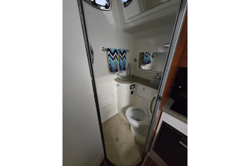 Slide: The Image of 2020 Regulator 41 boat bathroom with modern fixtures and chevron towel. - 51