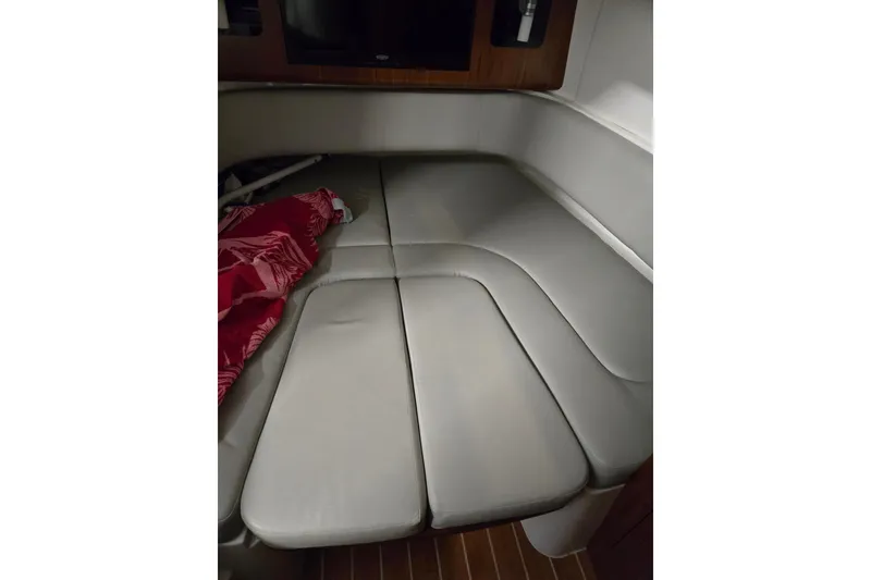 Slide: The Image of 2020 Regulator 41 boat cabin interior with cushioned seating and red blanket. - 57