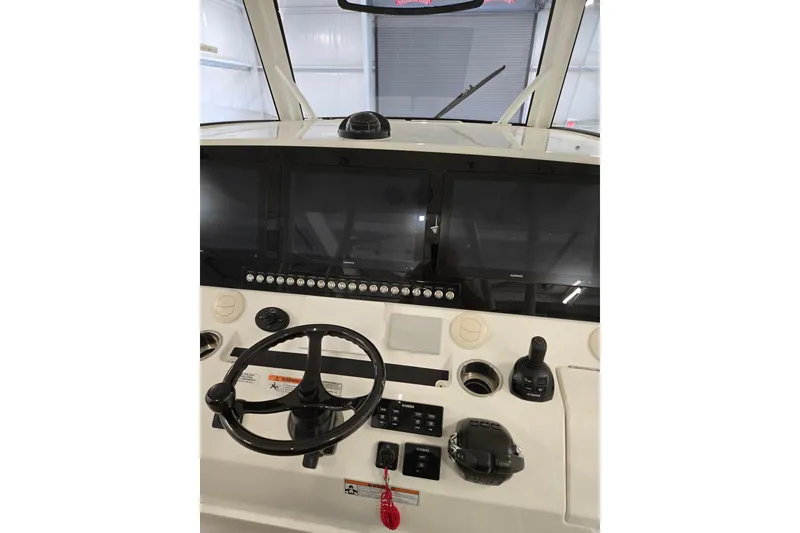 Slide: The Image of 2020 Regulator 41 boat dashboard with steering wheel and navigation screens. - 61