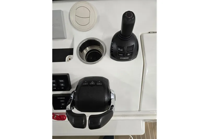 Slide: The Image of Control panel of 2020 Regulator 41 boat featuring Yamaha joystick and throttle. - 62