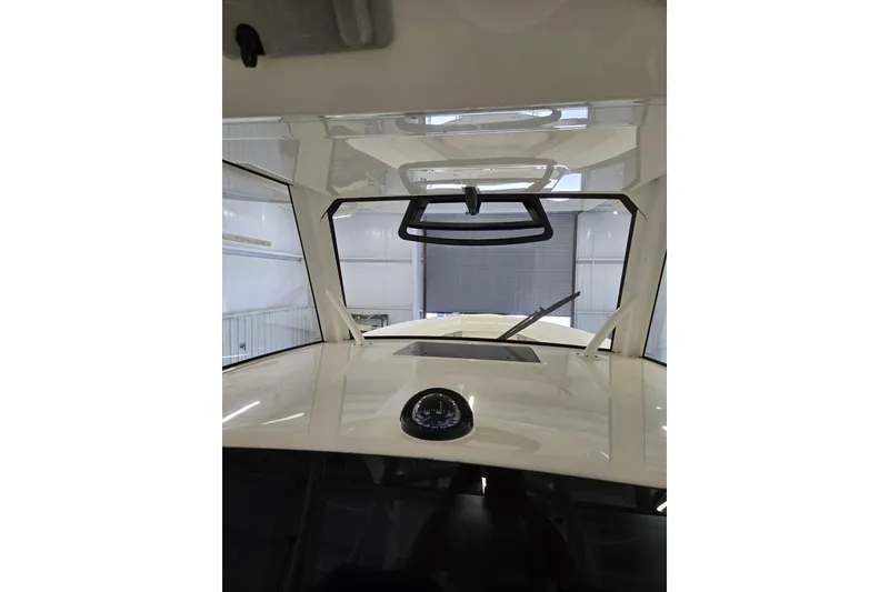 Slide: The Image of 2020 Regulator 41 boat interior with windshield and compass in a storage facility. - 63