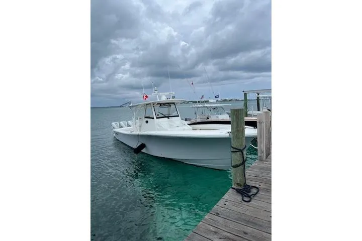 Slide: The Image of 2020 Regulator 41 boat docked on a cloudy day, turquoise water. - 71