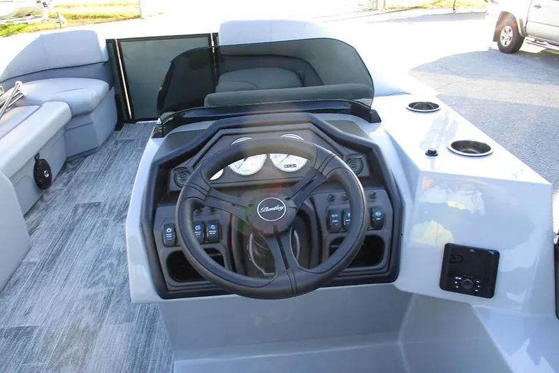 Slide: The Image of 2026 Bentley Pontoons Legacy 243 Navigator dashboard with steering wheel and controls. - 31