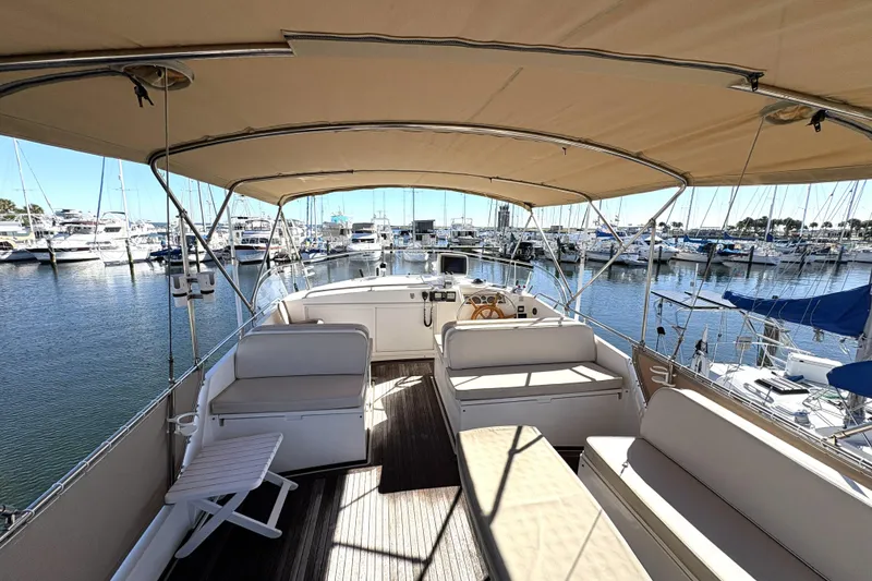 Slide: The Image of 1993 Grand Banks 42 Classic yacht interior with seating, docked at marina. - 10