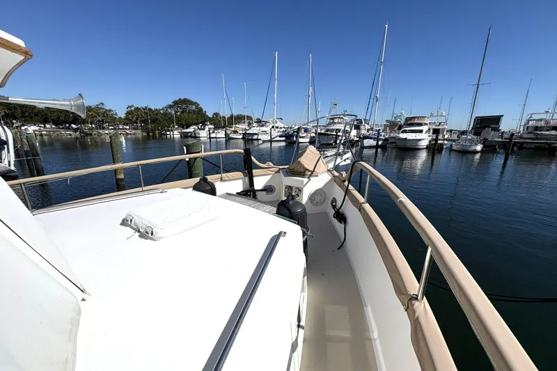 Slide: The Image of 1993 Grand Banks 42 Classic yacht docked in a marina under clear blue skies. - 11
