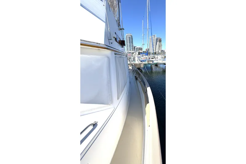 Slide: The Image of Side view of a 1993 Grand Banks 42 Classic yacht docked in a marina. - 13