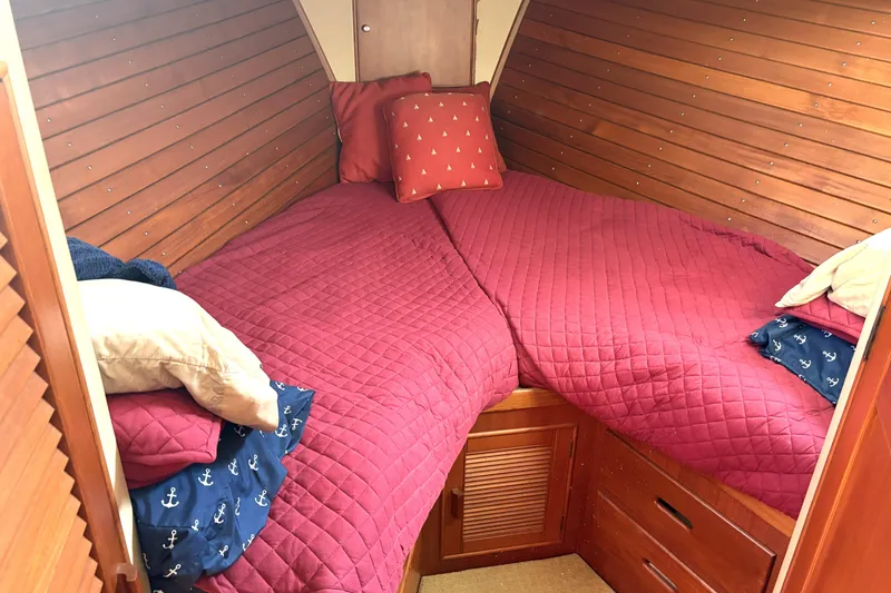 Slide: The Image of Cozy cabin interior of 1993 Grand Banks 42 Classic with red bedding and wooden paneling. - 15