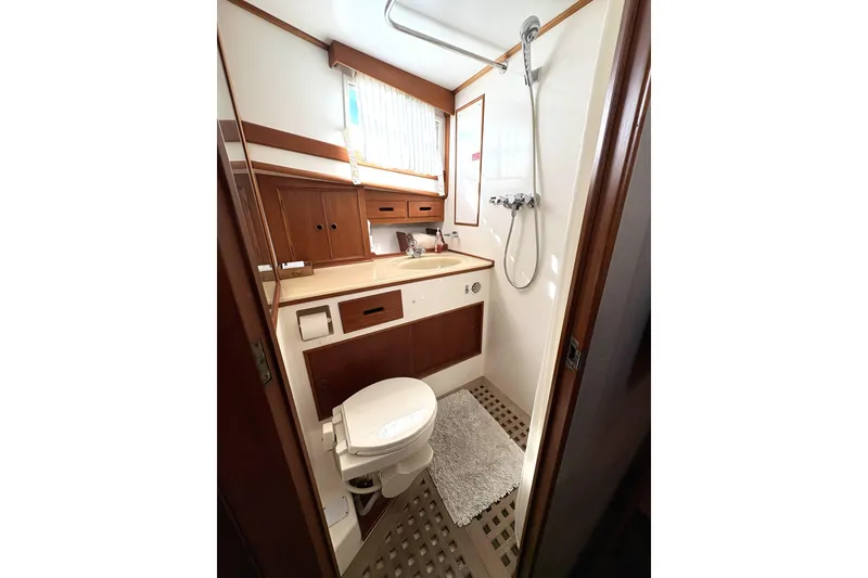 Slide: The Image of Bathroom interior of 1993 Grand Banks 42 Classic yacht, featuring shower and wooden cabinetry. - 16