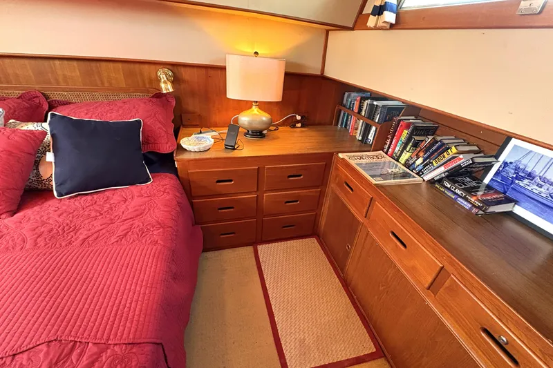 Slide: The Image of Cozy cabin interior of 1993 Grand Banks 42 Classic with red bedding and wooden furniture. - 19