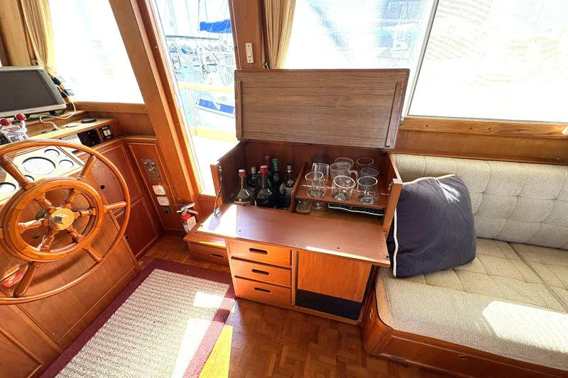Slide: The Image of Interior of 1993 Grand Banks 42 Classic yacht with wooden helm and bar area. - 22