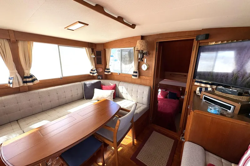 Slide: The Image of Interior of 1993 Grand Banks 42 Classic yacht with cozy seating and elegant wood finish. - 23