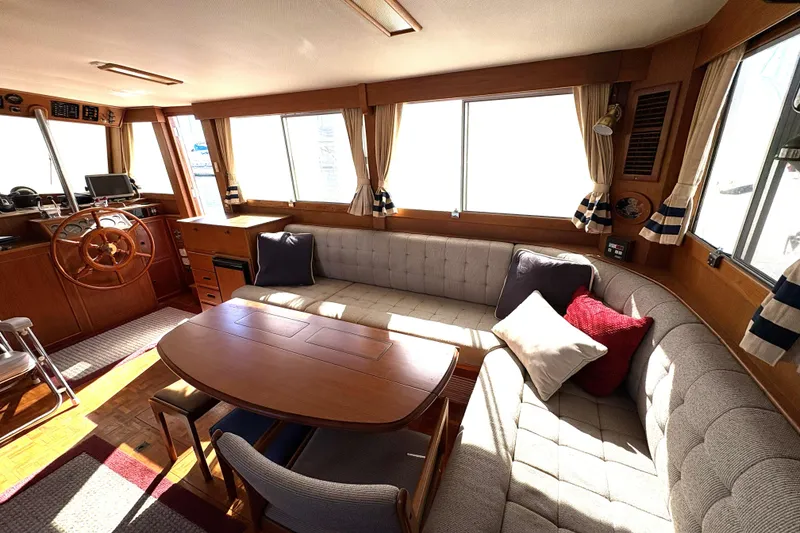 Slide: The Image of Interior of 1993 Grand Banks 42 Classic yacht with cozy seating and wooden helm. - 24