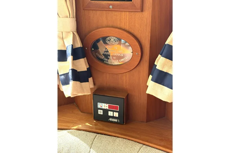 Slide: The Image of Plaque on 1993 Grand Banks 42 Classic yacht interior with striped curtains. - 27