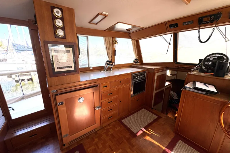 Slide: The Image of 1993 Grand Banks 42 Classic yacht interior with wooden cabinetry and nautical instruments. - 29