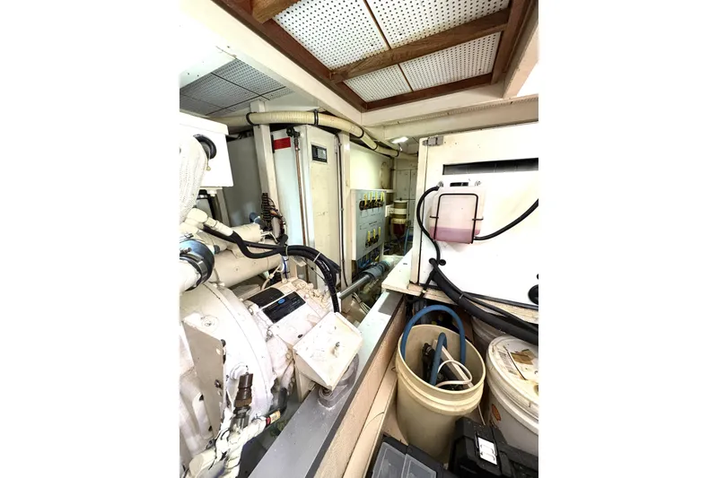 Slide: The Image of Engine room of 1993 Grand Banks 42 Classic yacht, showcasing mechanical components and storage. - 32