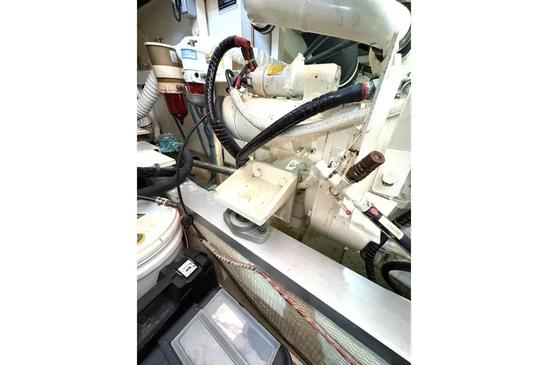Slide: The Image of Engine room of 1993 Grand Banks 42 Classic yacht, showcasing mechanical components and wiring. - 33