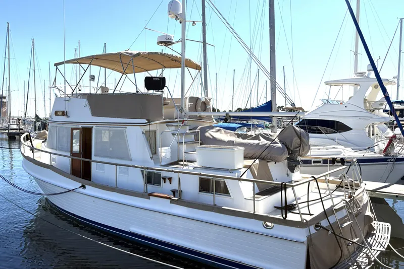 Slide: The Image of 1993 Grand Banks 42 Classic yacht docked in marina, featuring elegant design and spacious deck. - 5