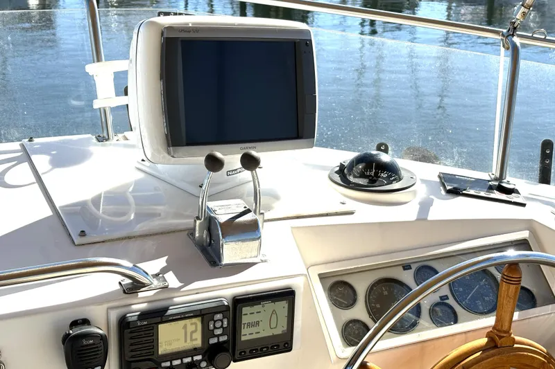 Slide: The Image of Helm of 1993 Grand Banks 42 Classic with navigation equipment and wooden steering wheel. - 7