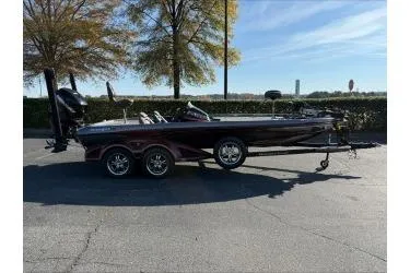 The Image of 2015 Ranger 521C boat on trailer, parked outdoors under clear sky. - 0