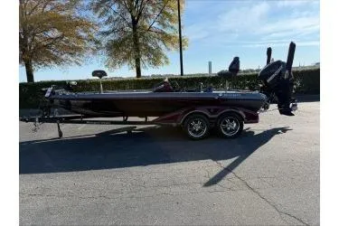 Slide: The Image of 2015 Ranger 521C boat on trailer, parked outdoors under clear sky. - 1