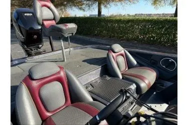 Slide: The Image of 2015 Ranger 521C boat interior with red and gray seating, outdoor setting. - 4