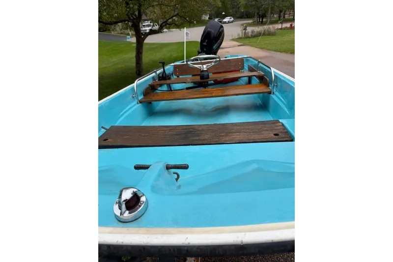 Slide: The Image of 1972 Boston Whaler Sourpuss 13 boat with blue interior and wooden seats. - 4