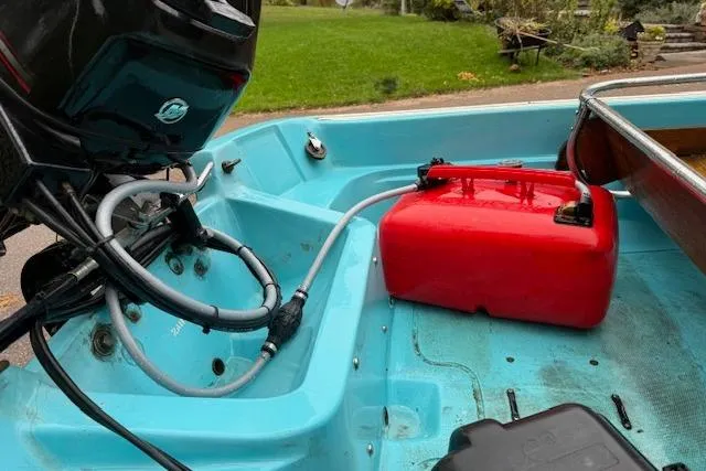 Slide: The Image of 1972 Boston Whaler Sourpuss 13 boat interior with motor and red fuel tank. - 6