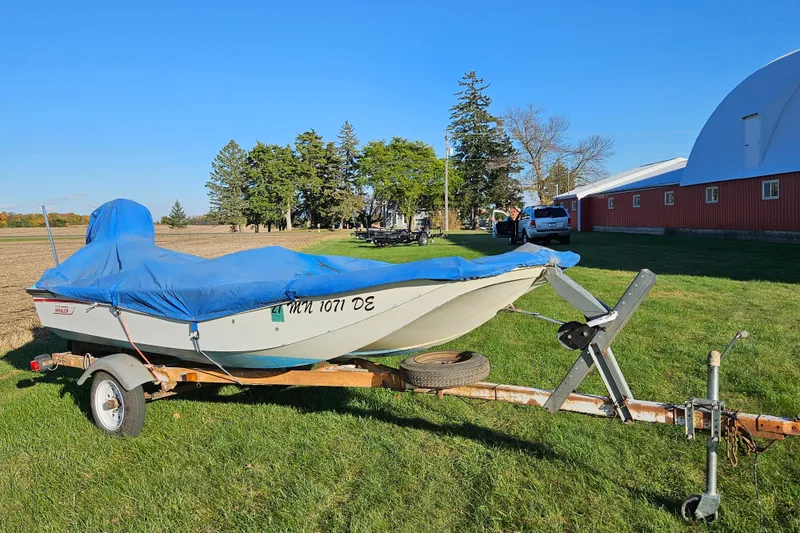 Slide: The Image of 1972 Boston Whaler Sourpuss 13 boat on trailer, covered, near red barn and trees. - 7
